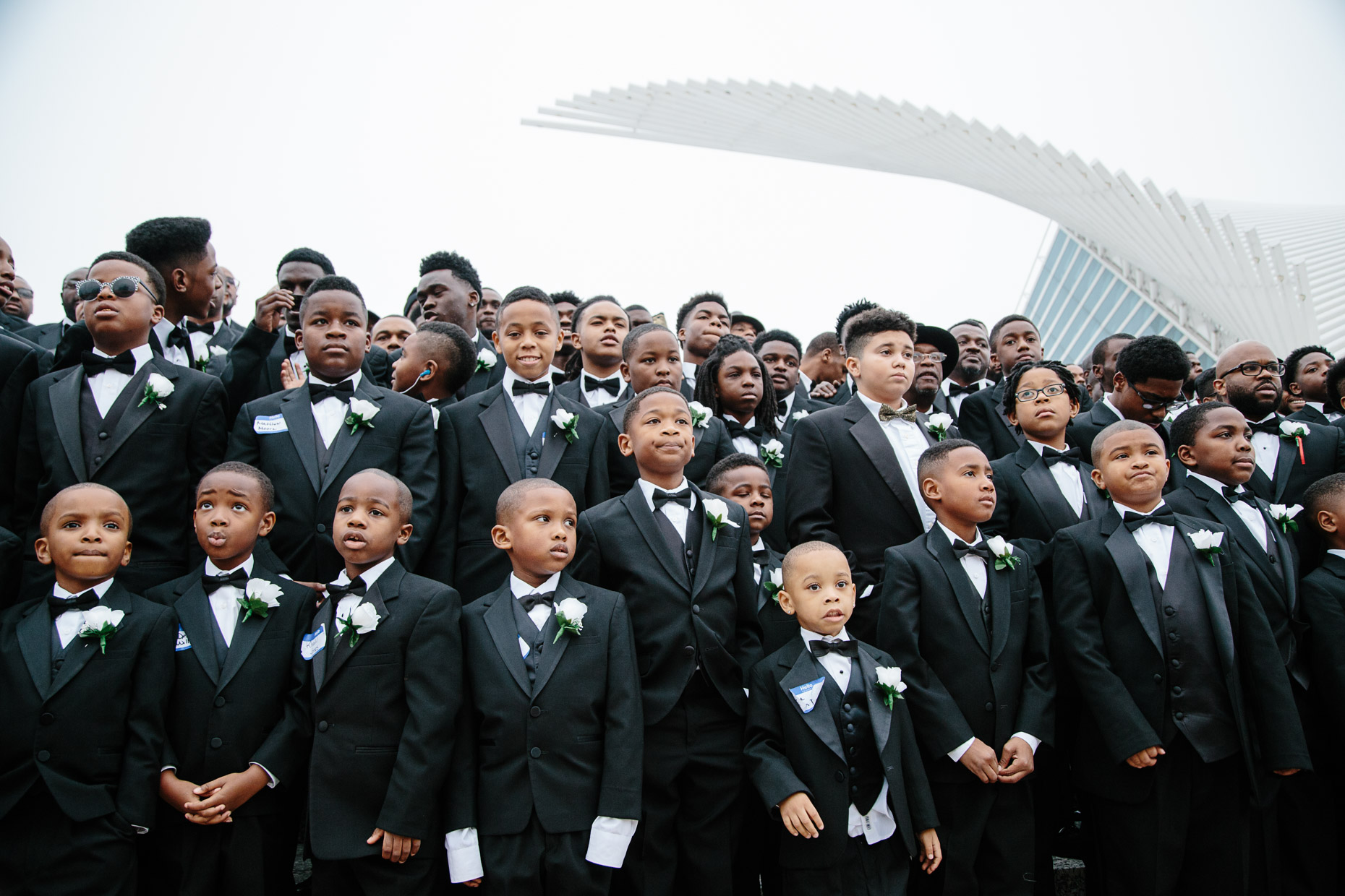 Participants of the 500 Black Tuxedos Event, organized by Andre Lee Ellis, gather for a group photo on the steps of the Milwaukee Art Museum on Saturday December 12th, 2015 in Milwaukee, Wisconsin.