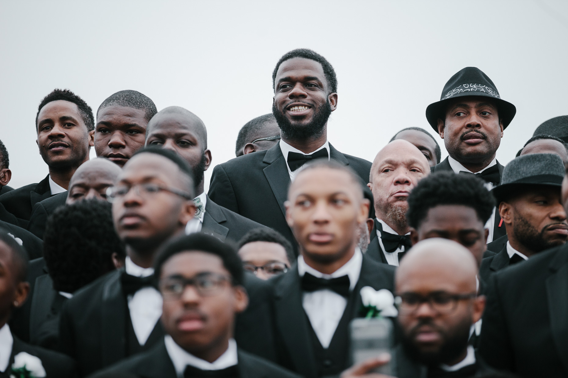 Participants of the 500 Black Tuxedos Event, organized by Andre Lee Ellis, gather for a group photo on the steps of the Milwaukee Art Museum on Saturday December 12th, 2015 in Milwaukee, Wisconsin.