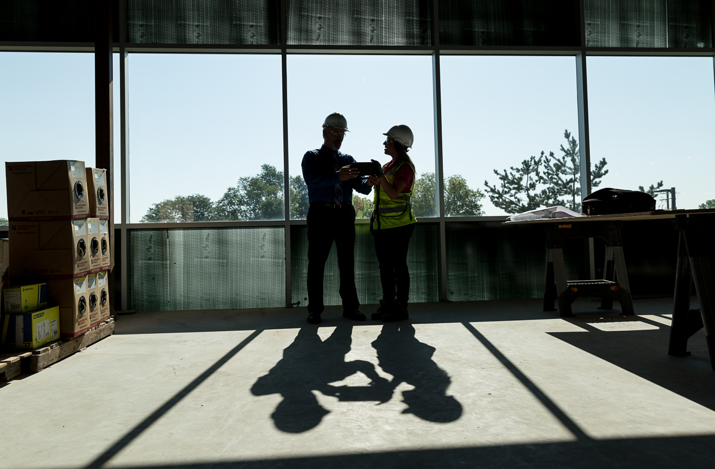 commercial photographer - a silhouette of construction workers on a construction site.