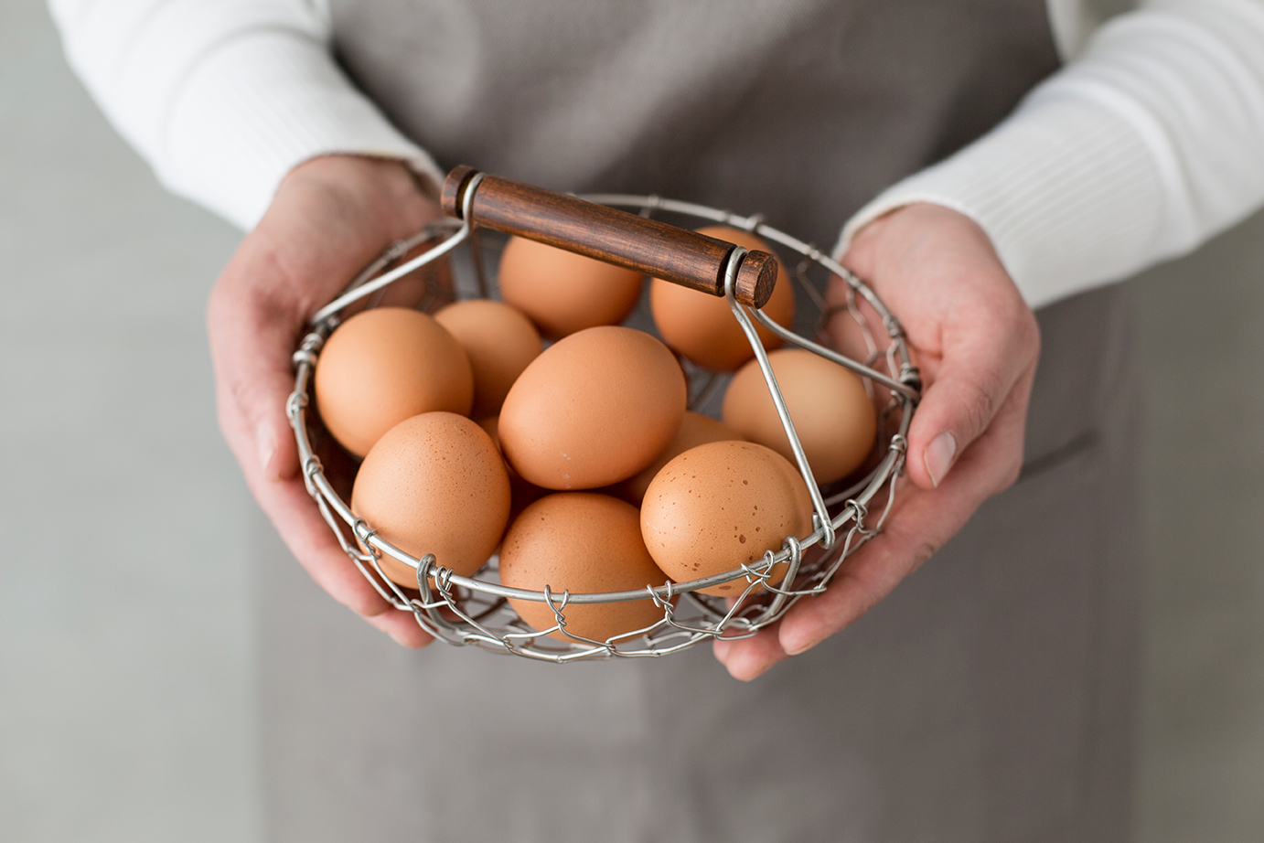 commercial food photographer - a chef holds a basket of fresh eggs