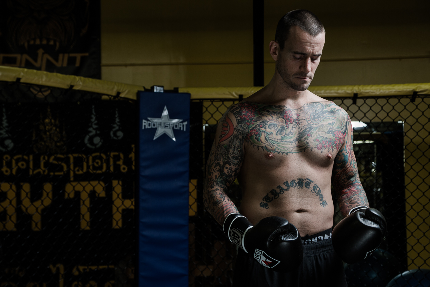 editorial sports photographer - CM Punk, aka, Phil Brooks, shirtless wearing boxing gloves at a gym