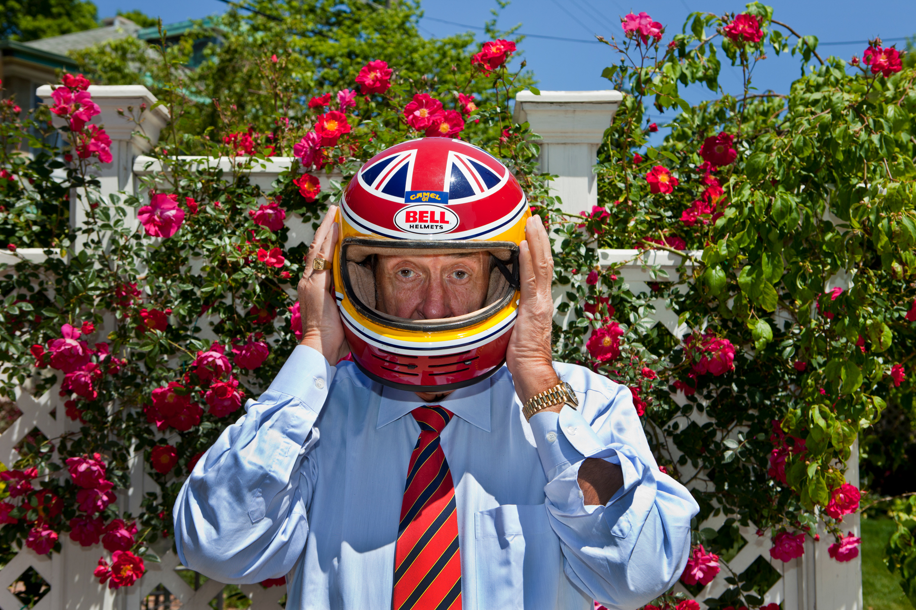 editorial photographer - portrait of David Hobbs wearing a racing helmet
