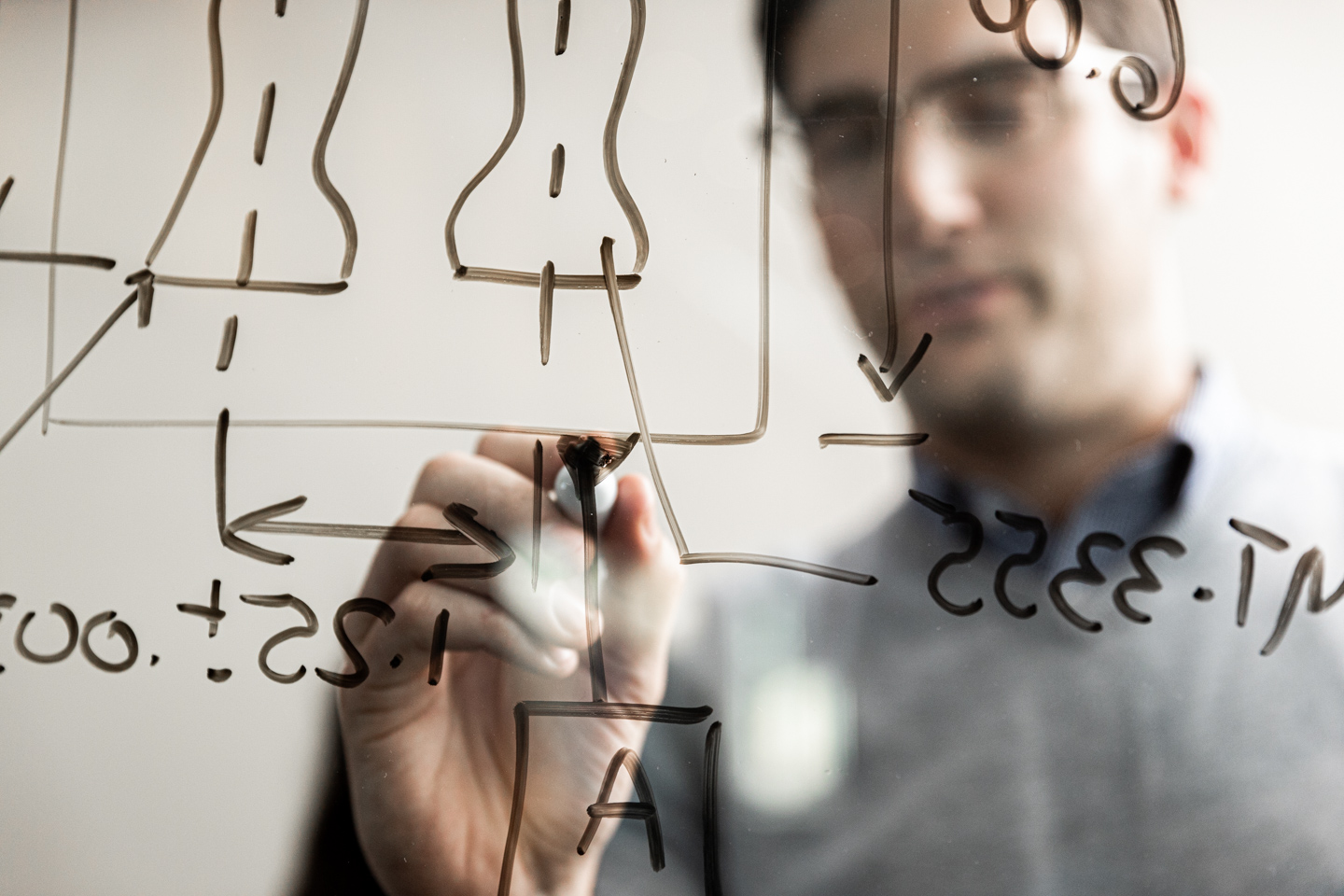 commercial photographer Milwaukee - an engineer writes notes onto glass