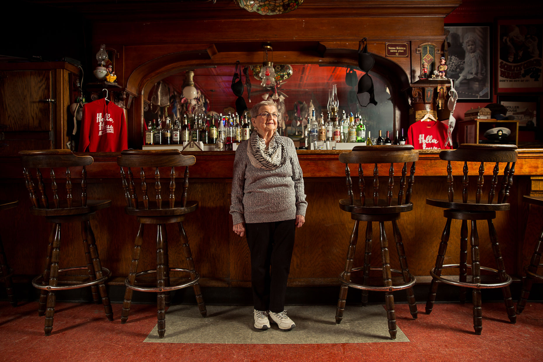 editorial photographer Milwaukee - Marcy Skowronski, stands in front of theThe Holler House bar in Milwaukee Wisconsin