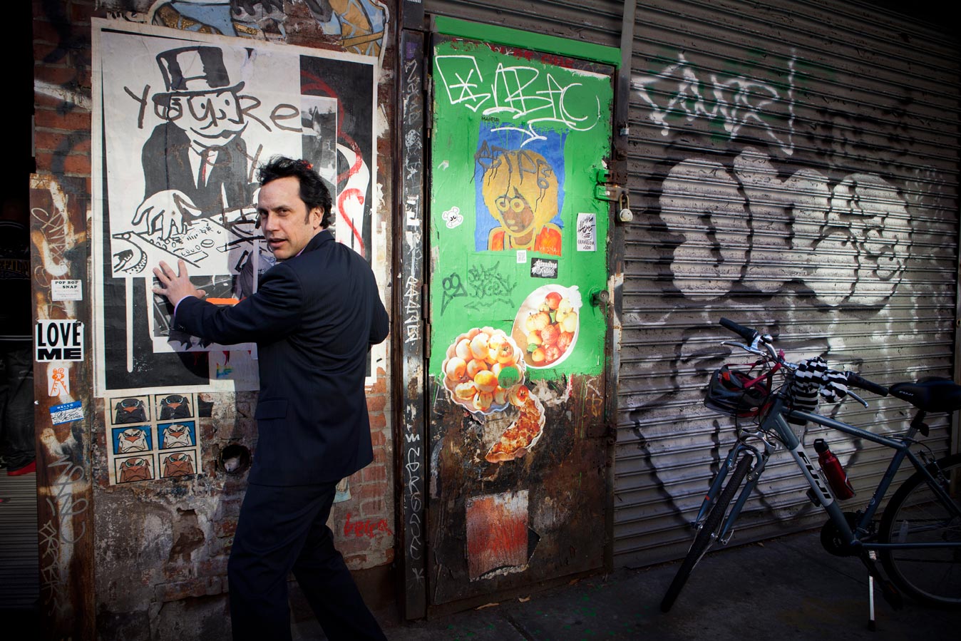 editorial photographer Midwest - Michael Melcher, author of The Creative Lawyer, stands next to a wall of Graffiti in NYC