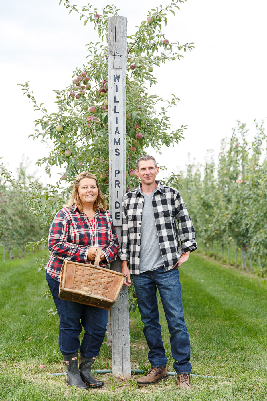 farm photographer - Jennifer and Joseph Fahey stand in their organic orchard 