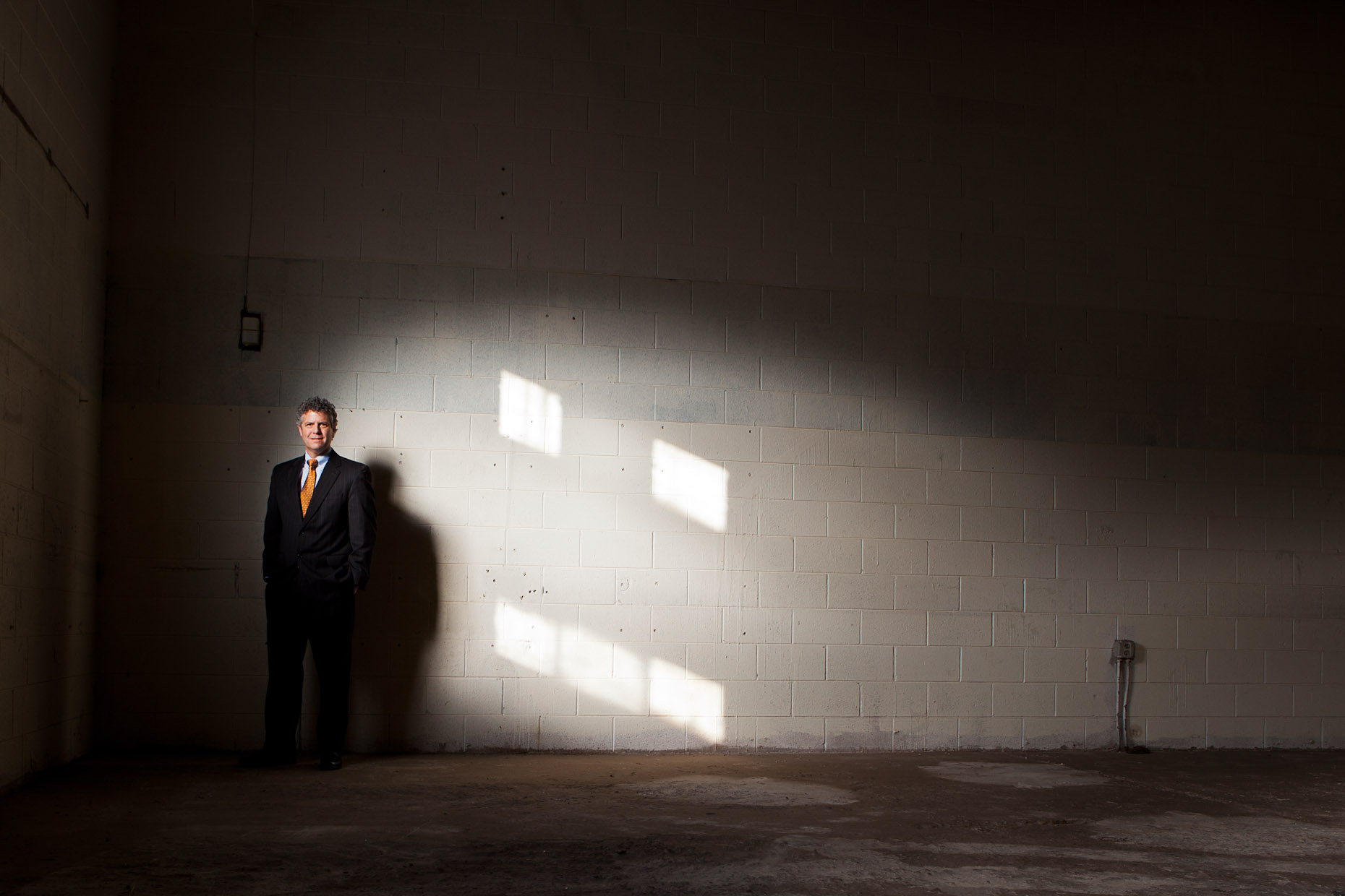creative editorial photographer - a real estate broker photographed in an empty building