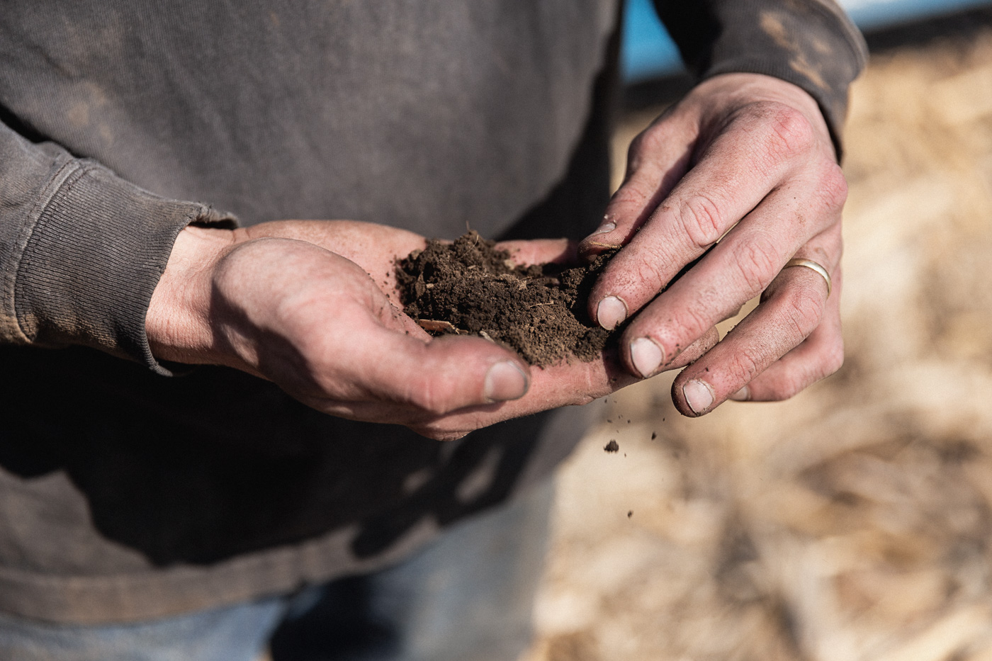 agriculture photographer Midwest - close up of a farmer sifting dirt through his hands