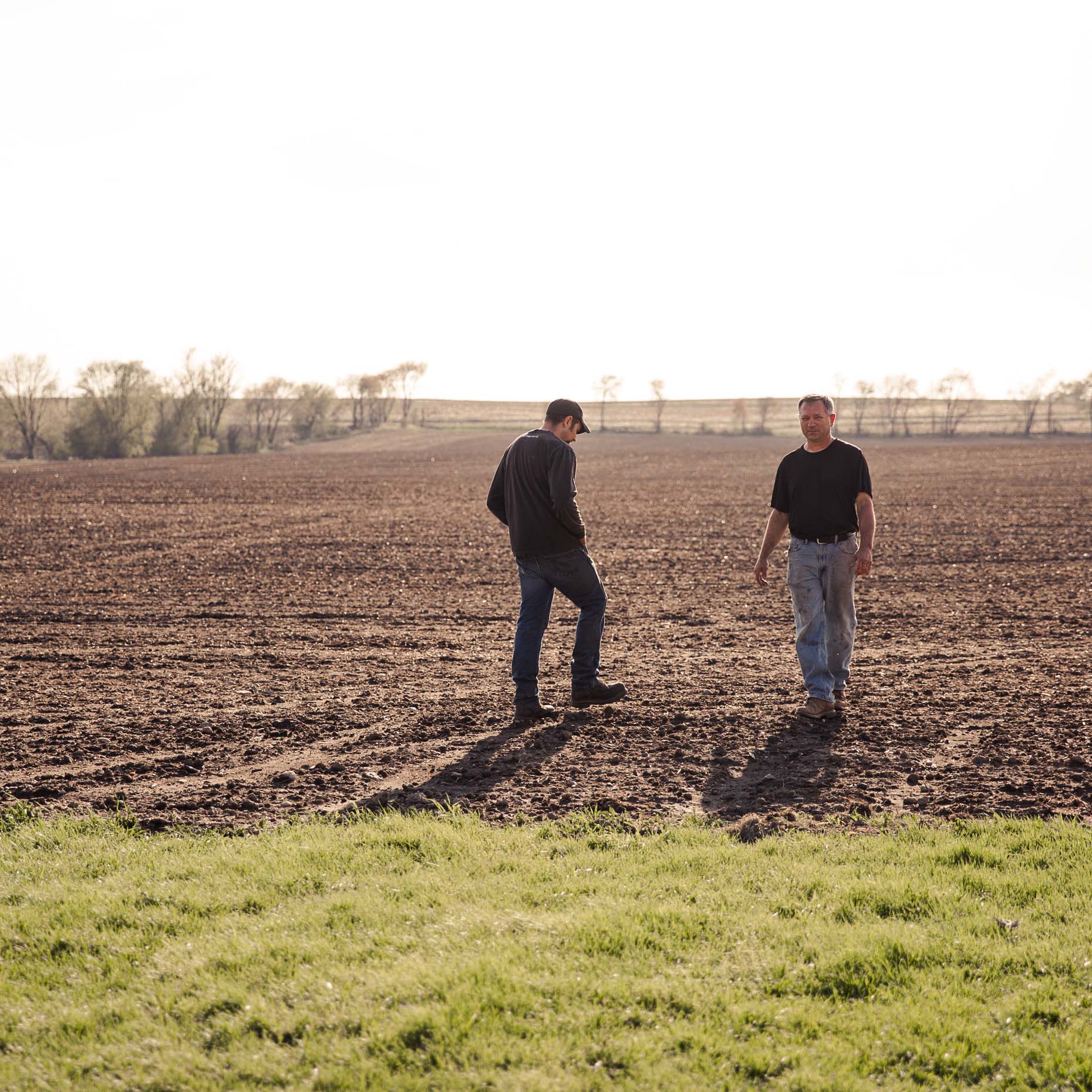 agriculture photographer Midwest - father and son farmer walking in a field